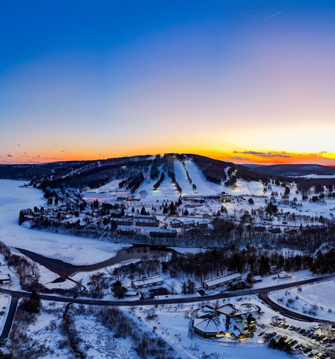 Aerial view of Wisp Resort and its ski slopes at winter sunset